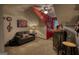 Finished bonus room with eclectic decor, neutral carpet, and an accent wall; a cozy couch invites relaxation at 55 Ashton Pl, Covington, GA 30016