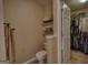 Bathroom including the toilet, next to the shelving and ample storage space of the closet at 55 Ashton Pl, Covington, GA 30016