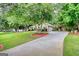 Beautiful home with mature trees, green lawn and long driveway at 55 Ashton Pl, Covington, GA 30016