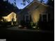 Exterior of a one story home at dusk featuring a sidewalk and manicured landscaping at 55 Ashton Pl, Covington, GA 30016