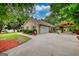 Charming home featuring lush landscaping and a covered parking area at 55 Ashton Pl, Covington, GA 30016