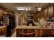 Well-lit kitchen with rustic wood accents, stainless steel appliances, and decorative overhead lighting at 55 Ashton Pl, Covington, GA 30016