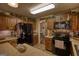 The kitchen features wooden cabinets, stainless steel appliances, and overhead accent lighting at 55 Ashton Pl, Covington, GA 30016