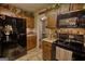 This kitchen has wooden cabinets, stainless steel appliances, and rustic-chic decor at 55 Ashton Pl, Covington, GA 30016