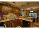 This eat-in kitchen has wooden cabinets, a modern appliance, and a breakfast bar at 55 Ashton Pl, Covington, GA 30016