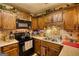 Spacious kitchen features wooden cabinets, modern appliances, and complementary backsplash at 55 Ashton Pl, Covington, GA 30016