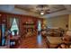 Cozy living room featuring a stone fireplace, plush sofa, and natural light, perfect for relaxation and entertaining at 55 Ashton Pl, Covington, GA 30016