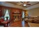 Inviting living room featuring a cozy stone fireplace and plush leather seating at 55 Ashton Pl, Covington, GA 30016