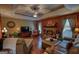 Spacious living room with a stone fireplace, ceiling fan, and comfortable leather furniture at 55 Ashton Pl, Covington, GA 30016