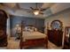 Spacious main bedroom featuring a tray ceiling, ceiling fan, and ample space for furnishings at 55 Ashton Pl, Covington, GA 30016