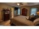 Cozy main bedroom with a four-poster bed, neutral tones, and large windows for natural light at 55 Ashton Pl, Covington, GA 30016