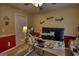 Functional home office with red accent wall, a modern computer desk, and a door to the hallway at 55 Ashton Pl, Covington, GA 30016