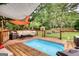 Inviting backyard pool with surrounding deck space and comfortable seating perfect for relaxation and outdoor gatherings at 55 Ashton Pl, Covington, GA 30016