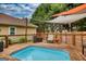 Backyard pool with a wooden deck and shade coverings offering a relaxing space for outdoor enjoyment at 55 Ashton Pl, Covington, GA 30016