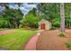 Well-maintained shed with a charming pathway, set amidst a beautifully landscaped yard at 55 Ashton Pl, Covington, GA 30016