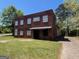 Two-story brick building with a dark awning shading the front entrance at 889 W Hightower Trl, Social Circle, GA 30025