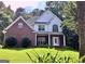 Attractive brick and vinyl sided home with a well-maintained lawn and mature trees at 90 Barrington Grange Dr, Sharpsburg, GA 30277