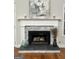 Cozy fireplace with stone surround and white mantel at 90 Barrington Grange Dr, Sharpsburg, GA 30277