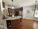Well-lit kitchen features a granite countertop island and stainless steel appliances at 90 Barrington Grange Dr, Sharpsburg, GA 30277