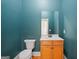 Bathroom with a modern vanity, toilet, and teal walls at 3451 Fairway Dr, College Park, GA 30337