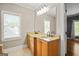 Bathroom with double sinks, granite countertop, and natural light at 3451 Fairway Dr, College Park, GA 30337