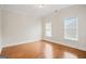 Sun-filled bedroom with hardwood floors and two windows providing ample natural light at 3451 Fairway Dr, College Park, GA 30337