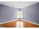 Cozy bedroom featuring hardwood floors, modern lighting, and a corner window at 3451 Fairway Dr, College Park, GA 30337