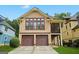 Charming home exterior featuring a two-car garage, green lawn and craftsman details at 3451 Fairway Dr, College Park, GA 30337