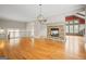 Cozy living room with stone fireplace, hardwood floors, and elegant chandelier providing soft, ambient light at 3451 Fairway Dr, College Park, GA 30337