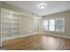 Living room features wood floors, built-in bookshelves, and a large window for natural light at 3451 Fairway Dr, College Park, GA 30337