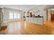Bright living room with hardwood floors, and arched entryways leading to the modern kitchen at 3451 Fairway Dr, College Park, GA 30337