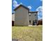 View of backyard, showcasing a well-maintained lawn and a patio with comfortable seating under a sunny sky at 301 Leland Ct, Mcdonough, GA 30253