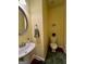 Half bathroom featuring a pedestal sink and toilet, complemented by neutral colors and a small decorative plant at 301 Leland Ct, Mcdonough, GA 30253