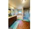Well-lit bathroom features a soaking tub, shower with curtain, and double vanity at 301 Leland Ct, Mcdonough, GA 30253