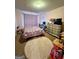 Cozy bedroom with a plush rug, decorated with a colorful unicorn-themed bedspread and a dresser with a television on top at 301 Leland Ct, Mcdonough, GA 30253