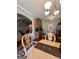 Open dining room with chandelier lighting, wooden cabinets and chairs at 301 Leland Ct, Mcdonough, GA 30253