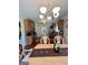 Open dining area with chandelier lighting and views into the kitchen at 301 Leland Ct, Mcdonough, GA 30253