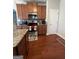 Well-equipped kitchen featuring stainless steel appliances, granite counters, and wooden cabinets at 301 Leland Ct, Mcdonough, GA 30253