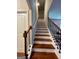 Elegant staircase with wooden steps and black metal railings, leading to the upper level at 301 Leland Ct, Mcdonough, GA 30253