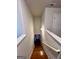 View of a staircase leading down to a lower level with hardwood steps and white banisters at 301 Leland Ct, Mcdonough, GA 30253