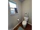 Toilet room features wall decor and a small window providing natural light at 301 Leland Ct, Mcdonough, GA 30253