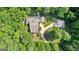 Aerial view of a beautiful home with a long driveway surrounded by lush trees at 654 Cannon Rd, Sharpsburg, GA 30277