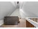 Finished attic space with a large dresser, neutral carpet, and interesting ceiling lines at 654 Cannon Rd, Sharpsburg, GA 30277