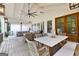 Spacious back porch featuring outdoor dining and living areas with comfortable seating at 654 Cannon Rd, Sharpsburg, GA 30277