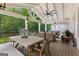Spacious back porch featuring an outdoor dining area and comfortable seating at 654 Cannon Rd, Sharpsburg, GA 30277