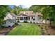 Expansive backyard featuring a screened porch, lush green lawn, and a charming white fence at 654 Cannon Rd, Sharpsburg, GA 30277