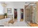 Bathroom featuring a soaking tub, walk-in closets, and tiled shower at 654 Cannon Rd, Sharpsburg, GA 30277