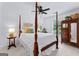 Bright bedroom with a four poster bed, neutral walls, and wood accents creating a warm and inviting space at 654 Cannon Rd, Sharpsburg, GA 30277
