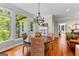 Bright breakfast nook with round wooden table, wicker chairs and views of the lush backyard at 654 Cannon Rd, Sharpsburg, GA 30277