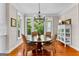 Bright breakfast nook with round wooden table, wicker chairs and views of the lush backyard at 654 Cannon Rd, Sharpsburg, GA 30277